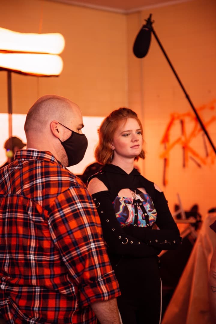 Behind the scenes photo 56 from Clone Cops production showing director danny dones and allison shrum prepare for a scene